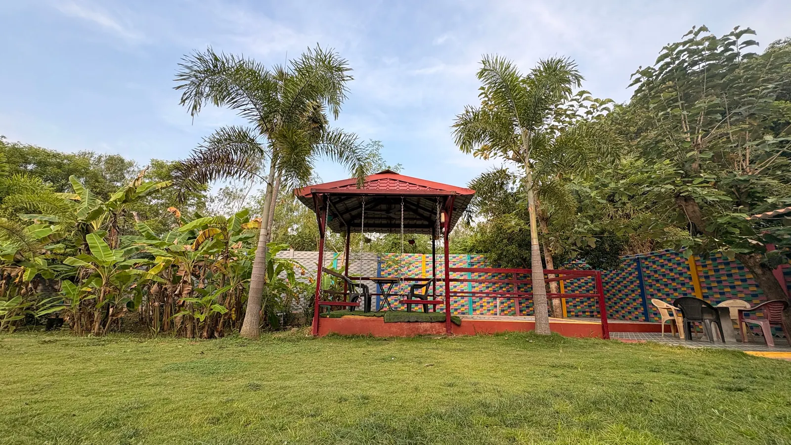 Garden gazebo and lawn surrounded by palm trees