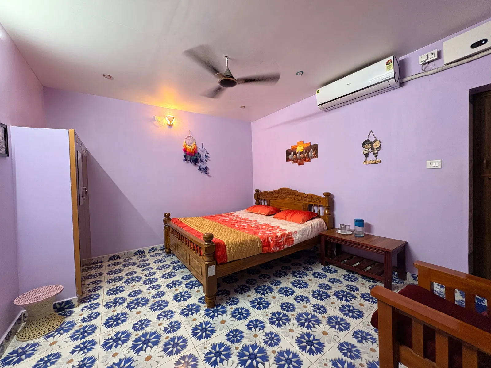 AC cottage bedroom with wooden bed and ceiling fan