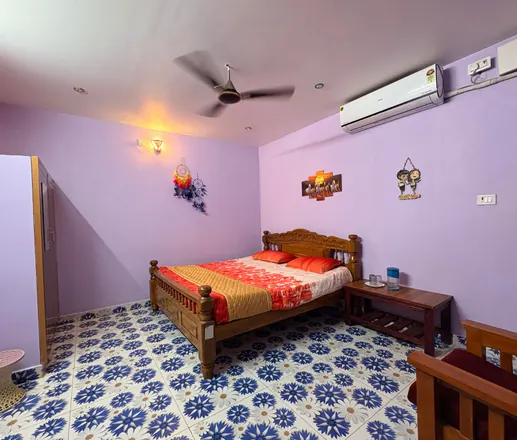 AC cottage bedroom with air conditioner and patterned floor
