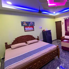 Cottage bedroom with carved wooden bed and LED ceiling lights